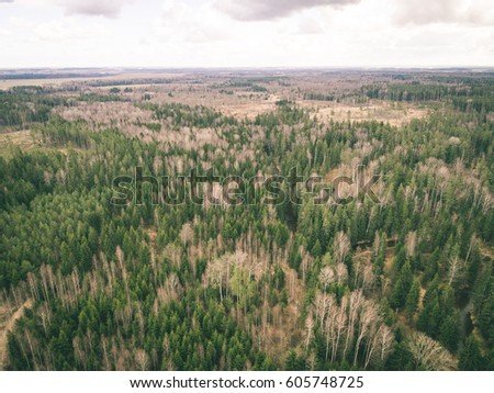aerial view of rural area with fields and forests in cloudy spring day. latvia - vintage retro