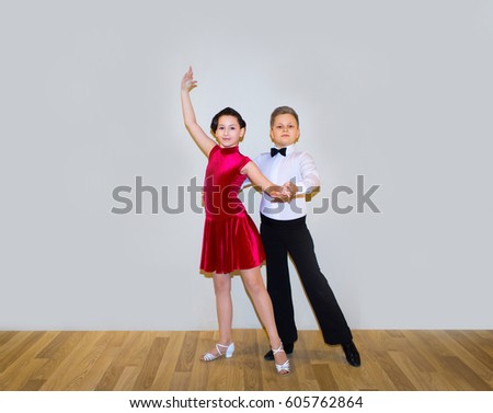 The young boy and girl posing at dance studio
