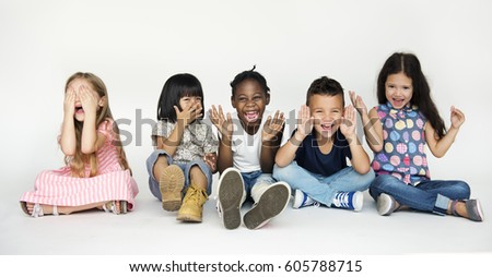 Diverse group of children doing peek a boo hand gesture Royalty-Free Stock Photo #605788715
