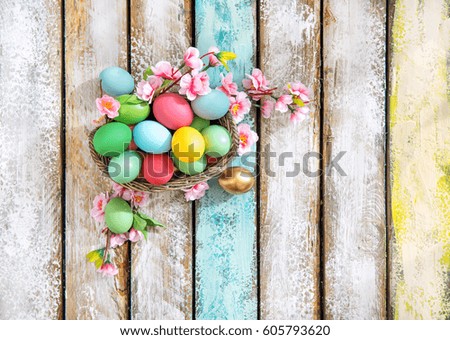 Easter eggs with flower decoration on wooden background