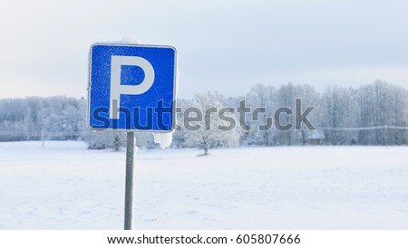 Parking sign in snow covered countryside