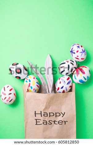 Easter eggs in a paper bag. Green background. Easter ideas. Easter eggs. Space for text. Black lettering on a bag happy easter.