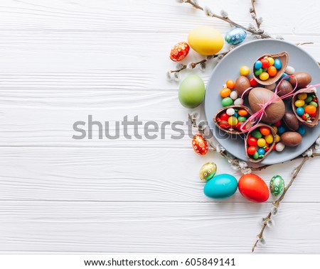 Easter concept. colored chocolate eggs and sweets on a white background Royalty-Free Stock Photo #605849141
