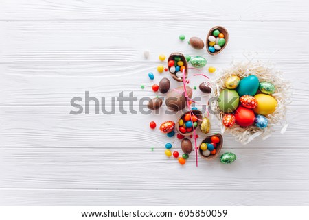 Easter concept. chocolate eggs and  colored sweets on a white background
 Royalty-Free Stock Photo #605850059