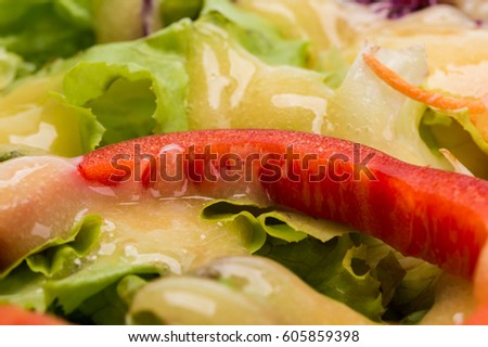 Fresh salad with dressing close-up