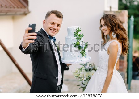 The bridegroom makes a selfie with her beautiful bride at the wedding