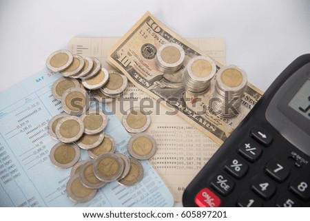 Savings, Piles of coins dollar currency and account book with calculator on white background, business idea. shallow focus