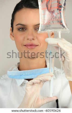 Portrait of a nurse making a drip