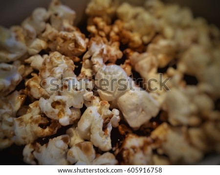 The caramel popcorn in box.focus the middle.blurry around.delicious,sweet and good taste.but fats and un healthy.
