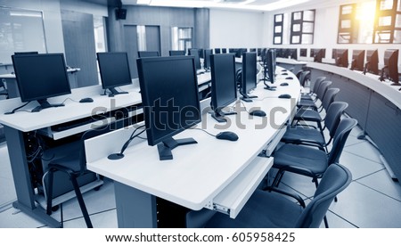 Group of computer neatly placed in a computer lab. Royalty-Free Stock Photo #605958425