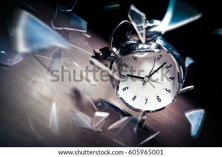 Busted alarm clock with broken glass on a dark background