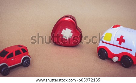 red car toy leave and ambulance car toy came into heart pain, treat your heart after broken heart concept