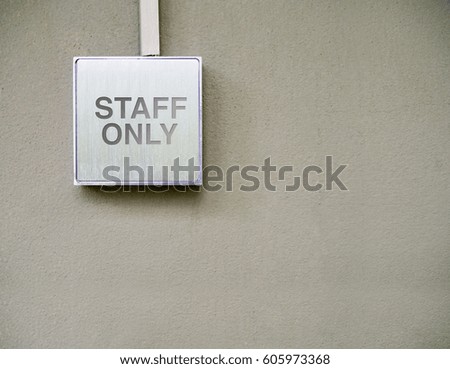 Staff only on silver sign, modern interior design on cement wall