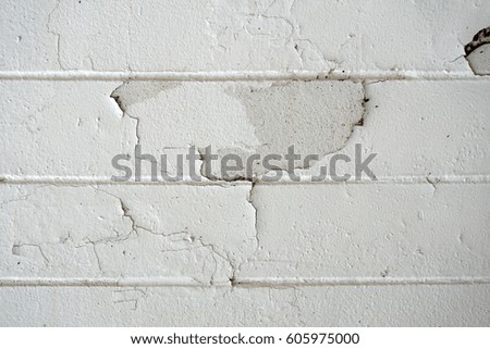 Cracks in paint on cement wall