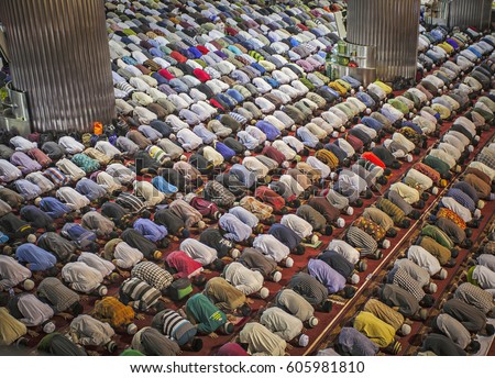Muslim Praying Together in Istiqlal Mosque, the biggest mosque in South East Asia, located in Jakarta, Indonesia. Royalty-Free Stock Photo #605981810