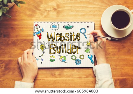 Website Builder text with a person holding a pen on a wooden desk
