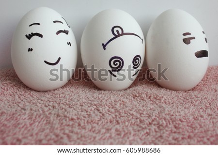 Eggs are funny with faces. Concept optimist, pessimist and realist. Photo for your design on a white background