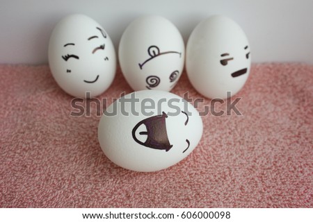 Eggs are funny with faces. Concept of a funny joke. Photo for your design on a white background