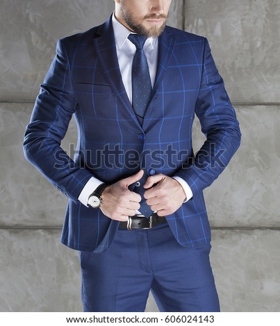 Businessman accesories. Blue suit, vest, leather belt and classic watch on hand. 