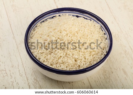 Raw rice heap in the bowl - ready for cooking