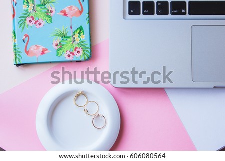 Styled image of a desktop with laptop, notebook and gold jewelry
