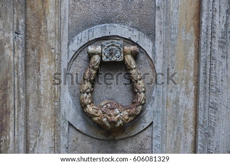 iron knocker of an old wooden door