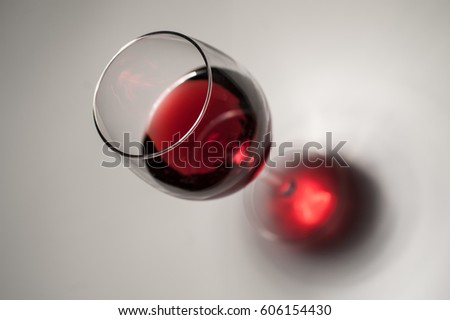 Marsala vine in elegant vineglass on gray background