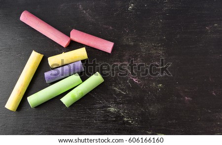 colorful chalks on blackboard background.