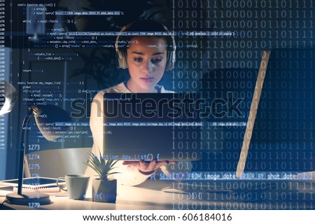 Program development concept. Young woman listening to music while working with laptop Royalty-Free Stock Photo #606184016