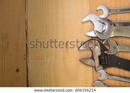 Various sizes of spanner/wrench over wooden background