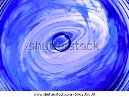 moving ink in water spiral abstract, purple and white
