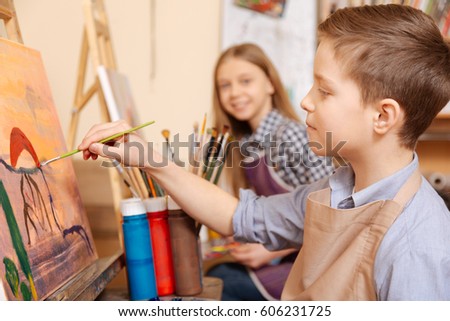 Positive children painting at the art class Royalty-Free Stock Photo #606231725