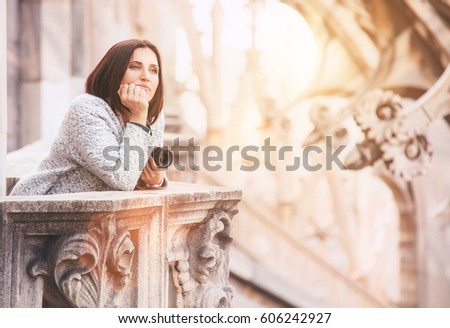 Tourist woman enjoy with calm atmosphere on the roof of Milano Cathedral (Duomo)