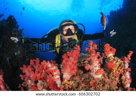 Female scuba diver explores coral reef