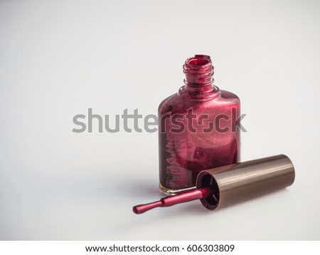 A Nail polish with open a bottle the color in dark red with isolate background