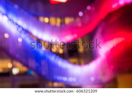 The blurred light  in front of the modern building  in city at night. Defocused background.