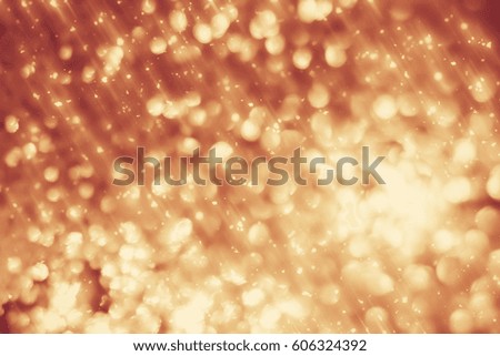 Golden abstract sparkles or glitter lights. Festive gold background.defocused circles bokeh or particles. Valentines day template.
