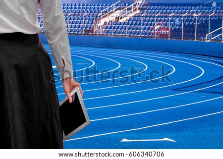 business Football Manager woman working Using tablet on the Sports stadium . happy at work Concept .