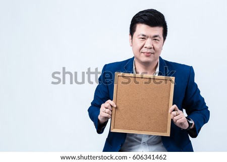 business asian man with blank cork board present for something