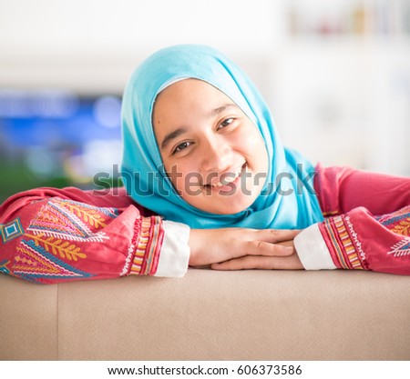 Muslim girl smiling at home indoors