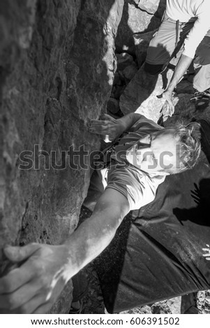 From above black and white shot of man climbing rock wall. Villanueva del Rosario, Malaga, Spain