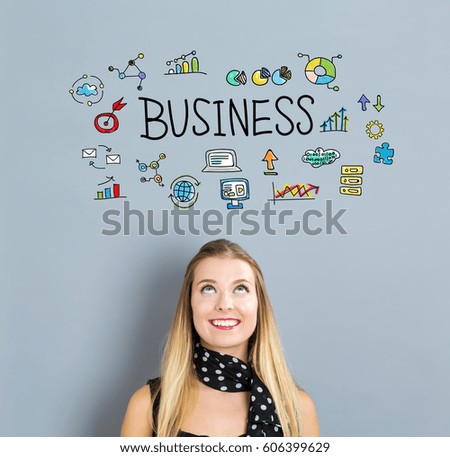 Business concept with happy young woman on a gray background