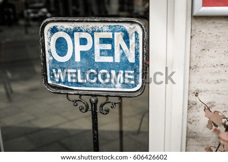 We are open, you are welcome sign in shop window