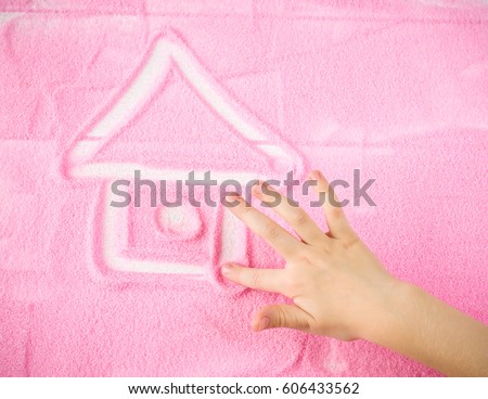 Child's hand draws a beautiful house of your dreams. The concept of wish fulfillment.
