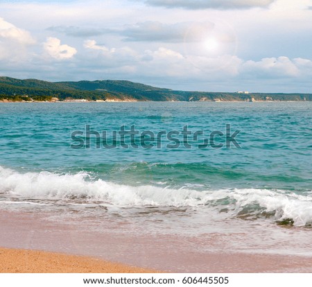 A beautiful sandy shore of the Mediterranean Sea and a heavenly landscape with a sunny sky 