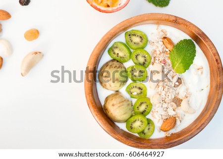 Breakfast. Muesli with exotic fresh fruit on a white background