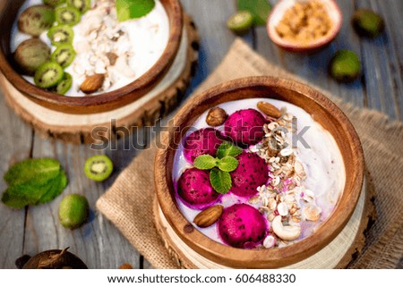 Breakfast. Muesli with exotic fresh fruit on wooden background