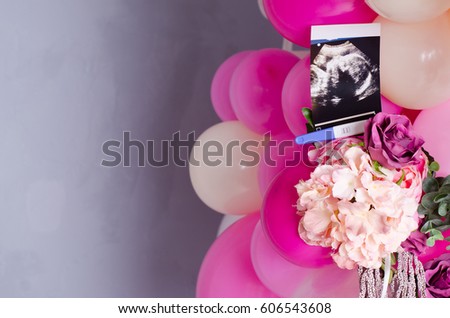 Concept photo ultrasound and pregnancy tests lie in pink balloons