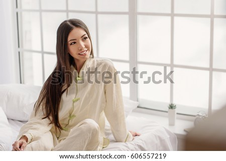 Cheerful young female situating in room