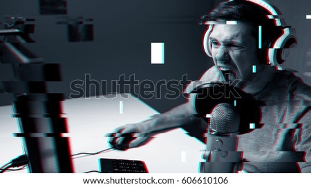 technology, gaming, entertainment and people concept - angry screaming young man in headset with pc computer playing game at home and streaming playthrough or walkthrough video over glitch effect